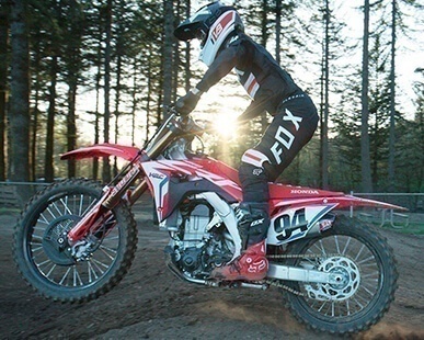 Dirtbike background image for the Pre-Owned Inventory call-to-action button